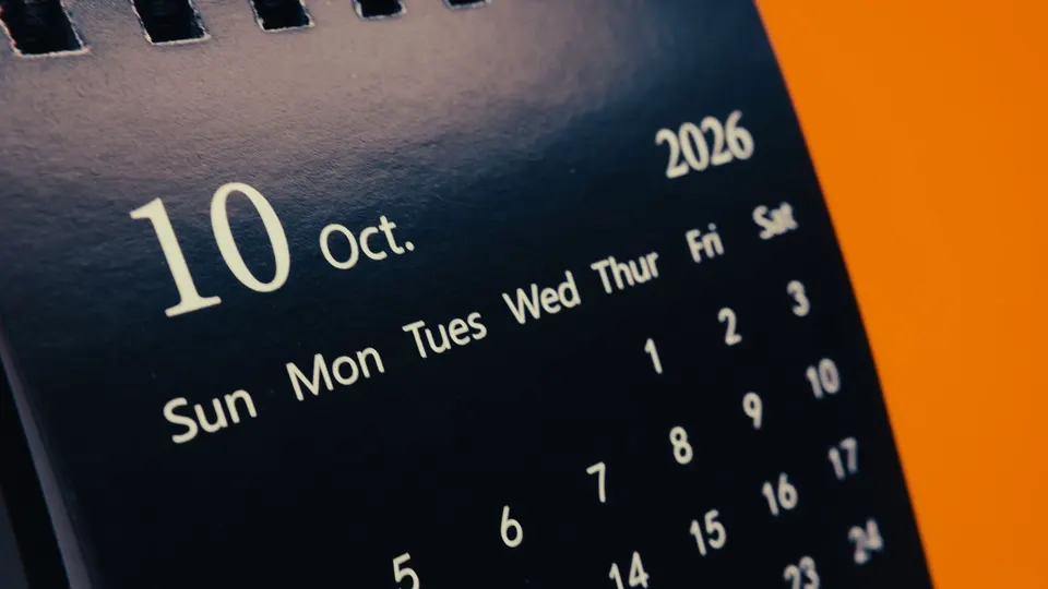 A desk calendar showing October 2026