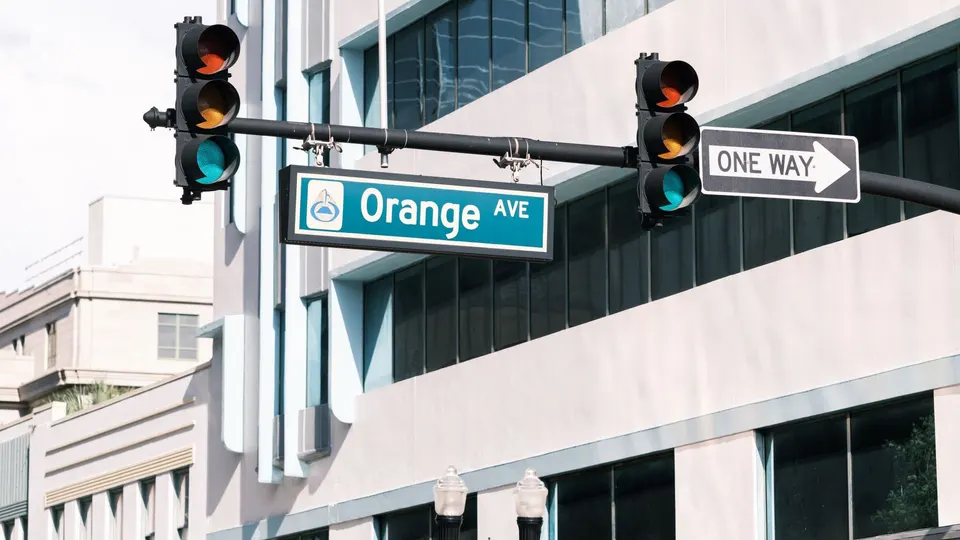 Traffic signals and street-name signs at a city intersection
