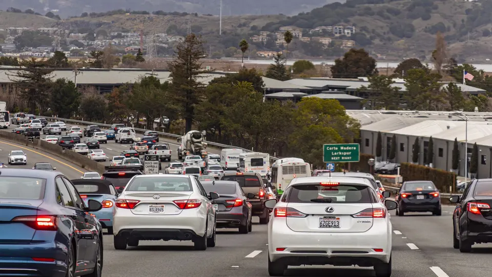 Slow traffic on a Bay Area freeway with hills behind