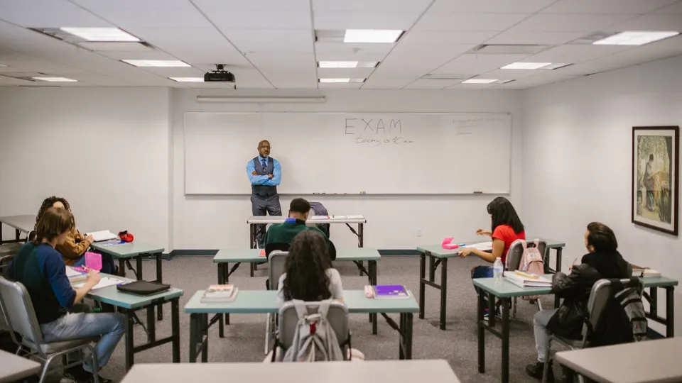 Students at desks in a classroom with an instructor at the front