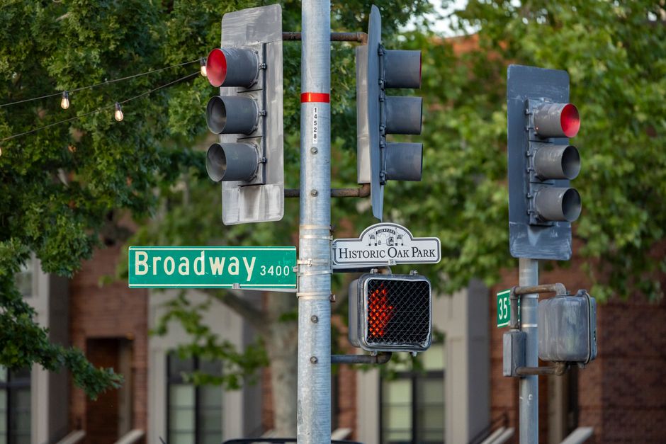 Red traffic lights over an intersection with a street-name sign